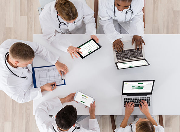 him professionals using vitalchart medical record retrieval software at office