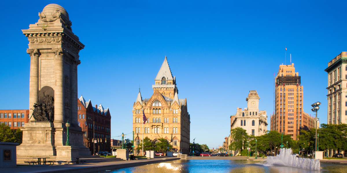 A view of historic buildings and the fountain in downtown Syracuse, New York.