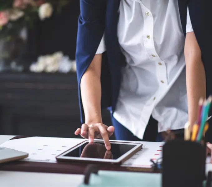 Person using a tablet at a desk