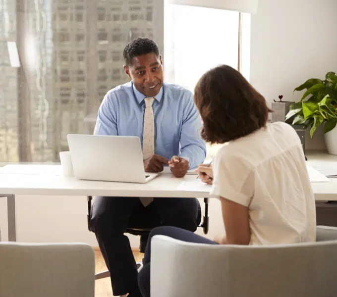 Professional meeting with a client across a desk in an office