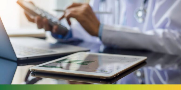 vitalchart physician with laptop calculator 1200x600